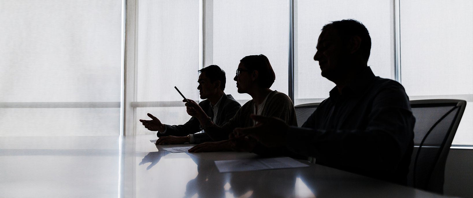 Three people reviewing a SSDI case.